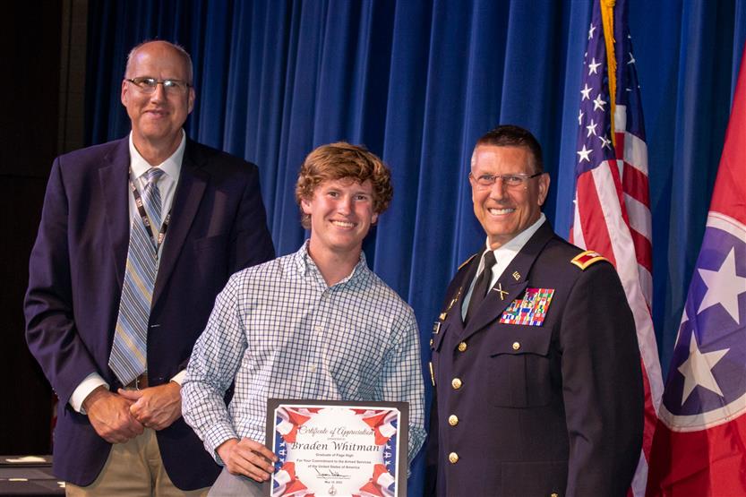 A student is honored for serving in the US Armed Forces after high school